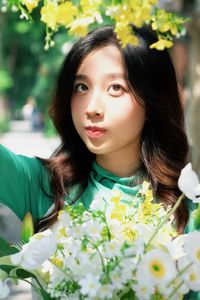 Captivating Smile: Young Woman in Green Embraces Nature's Serenity 1000019864-1