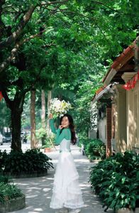 Captivating Smile: Young Woman in Green Embraces Nature's Serenity 1000019864-9