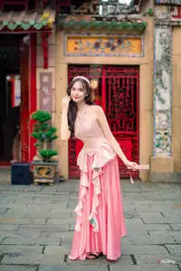 Graceful Woman in Pink Dress Amidst Ancient Heritage Charm 1000025280-2