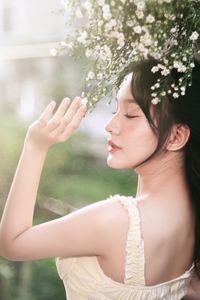 Serene Natural Beauty: Gentle Girl in Cream Dress Amidst Lush Garden-5