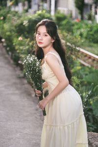 Serene Natural Beauty: Gentle Girl in Cream Dress Amidst Lush Garden-9