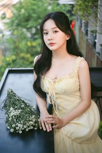 Serene Natural Beauty: Gentle Girl in Cream Dress Amidst Lush Garden-12