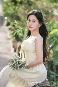 Serene Natural Beauty: Gentle Girl in Cream Dress Amidst Lush Garden-10