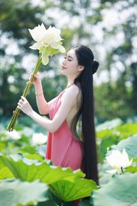 Elegant Vietnamese Girl in Pink Ao Yem by Lotus Pond, Capturing Traditional Beauty and Serenity-6