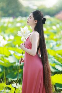 Elegant Vietnamese Girl in Pink Ao Yem by Lotus Pond, Capturing Traditional Beauty and Serenity-0