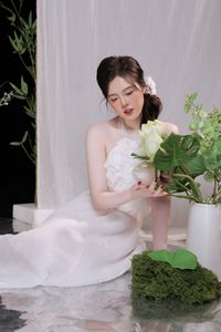 Elegant Vietnamese Girl in White, Embracing Tea Ceremony and Lotus Flowers – Traditional Beauty.-9