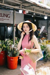 Vietnamese Grace: Elegant Girl in Traditional Flower Market, Discover Vibrant Culture 1000019476-5