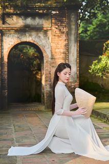 Elegant Vietnamese Woman in Traditional White Ao Dai, Gracing an Ancient Pathway | 1000017528-8