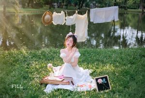 Serene Young Woman in White Dress Reading Book in Lush Nature-3