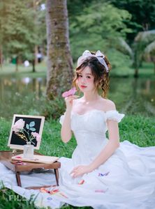 Serene Young Woman in White Dress Reading Book in Lush Nature-2