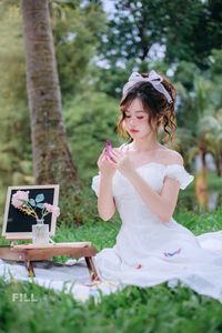 Serene Young Woman in White Dress Reading Book in Lush Nature-1