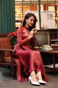Discover Vietnamese Ao Dai Beauty: Elegant, Graceful Girl in a Cafe Setting-14