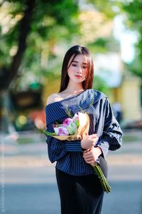 Elegant Beauty Charming Vietnamese Girl with Fresh Flowers on Street Captivating Street Fashion Style-5