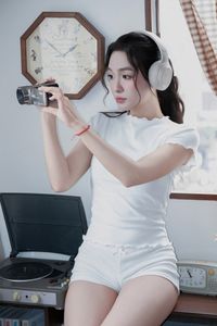 Young Woman Relaxing with Headphones & Music in Cozy Kitchen: Serene Home Lifestyle Moment-2