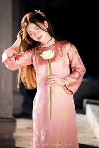 Captivating Serenity: Vietnamese Girl in Pink Ao Dai with Lotus Flowers1730591-0