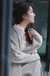 Discover the elegant charm of a gentle woman captured in a serene, thoughtful moment 176403855-5