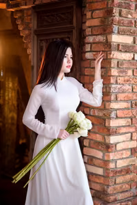 VGU No.69: Graceful Vietnamese beauty in pristine white Ao Dai with pure lotus, exuding captivating Asian charm.-3