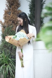 Elegant Vietnamese Ao Dai Beauty Amidst Vibrant Flower Market: Youthful Charm-3