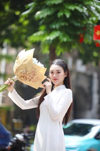 Elegant Vietnamese Ao Dai Beauty Amidst Vibrant Flower Market: Youthful Charm-1