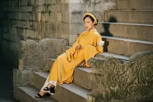 Discover the Graceful Beauty of a Vietnamese Woman in Radiant Yellow Ao Dai with Pure Lotus 1000025235-3