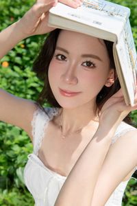 Elegant Young Woman in White Dress Amidst Greenery | Natural Summer Beauty-1