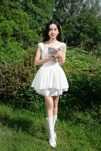 Elegant Young Woman in White Dress Amidst Greenery | Natural Summer Beauty-0