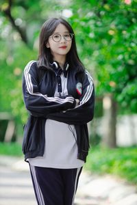 Radiant Youth: Girl in Uniform Playfully Blowing Bubbles in Lush Greenery 1000019736-3