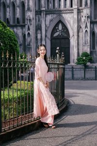 Elegant Woman in Pink Ao Dai at Hanoi Grand Cathedral - Vietnamese Cultural Charm-9