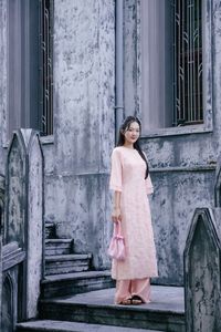 Elegant Woman in Pink Ao Dai at Hanoi Grand Cathedral - Vietnamese Cultural Charm-7