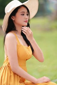 Charming Girl in Yellow Dress with Wide-Brim Hat Outdoors-4