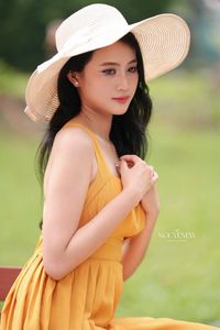 Charming Girl in Yellow Dress with Wide-Brim Hat Outdoors-7