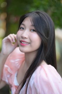 Radiant smile of a young, elegant Vietnamese girl in a pink and white dress.-1