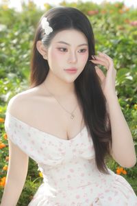 Graceful Woman in White Floral Dress Amidst Serene Summer Nature-3