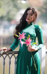 Vietnamese Grace: Elegant Woman in Green Ao Dai with Pink Lotus Flower 1000025232-5