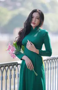 Vietnamese Grace: Elegant Woman in Green Ao Dai with Pink Lotus Flower 1000025232-10