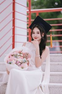Beautiful Female Graduate Embraces Success at Graduation Ceremony-0