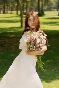 Gentle Beauty: Girl in Pristine White Dress with Pink Rose Bouquet Amidst Nature, Elegant Summer Style 1000019683-10