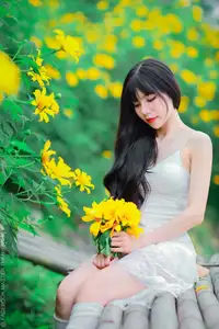 Graceful Young Woman in White Dress Amidst Vibrant Yellow Flowers 1000026997-10