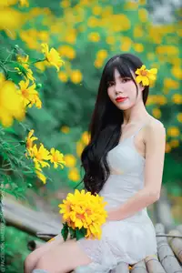 Graceful Young Woman in White Dress Amidst Vibrant Yellow Flowers 1000026997-1