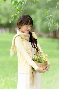 Pure Young Woman with Vibrant Yellow Flowers: Natural Beauty in a Lush Green Setting 1000019709-4