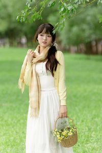 Pure Young Woman with Vibrant Yellow Flowers: Natural Beauty in a Lush Green Setting 1000019709-8