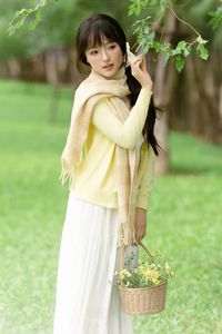Pure Young Woman with Vibrant Yellow Flowers: Natural Beauty in a Lush Green Setting 1000019709-3