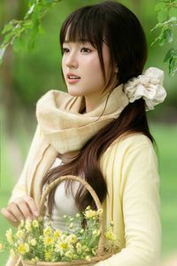 Pure Young Woman with Vibrant Yellow Flowers: Natural Beauty in a Lush Green Setting 1000019709-13