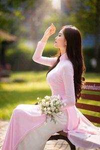 Elegant Vietnamese Woman in Pink Ao Dai Gracing a Sunny Park-3