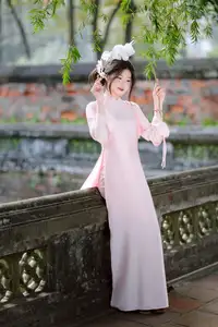 Elegant Vietnamese Beauty: Young Woman Gracefully Posing in Pink Ao Dai with White Orchids 1000026874-7