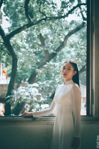 Graceful Vietnamese Girl in White Ao Dai by Window, Celebrating Traditional Beauty-15