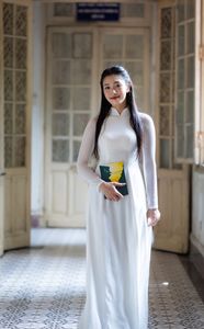 Graceful Vietnamese Girl in White Ao Dai by Window, Celebrating Traditional Beauty-3