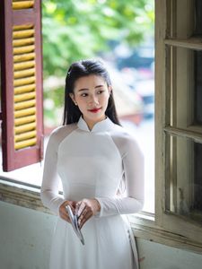 Graceful Vietnamese Girl in White Ao Dai by Window, Celebrating Traditional Beauty-5