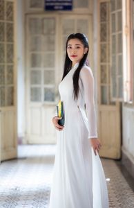 Graceful Vietnamese Girl in White Ao Dai by Window, Celebrating Traditional Beauty-1