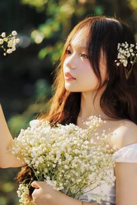 Captivating Portrait: Gentle Girl's Natural Beauty with Pure White Flowers in Golden Sunlight. Discover Her Grace.-4